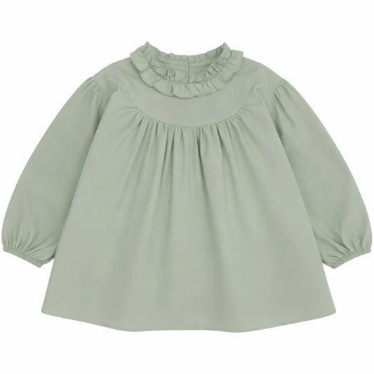 A sage green long-sleeve baby blouse with a ruffled mock neck and gathered sleeves, shown against a plain white background.