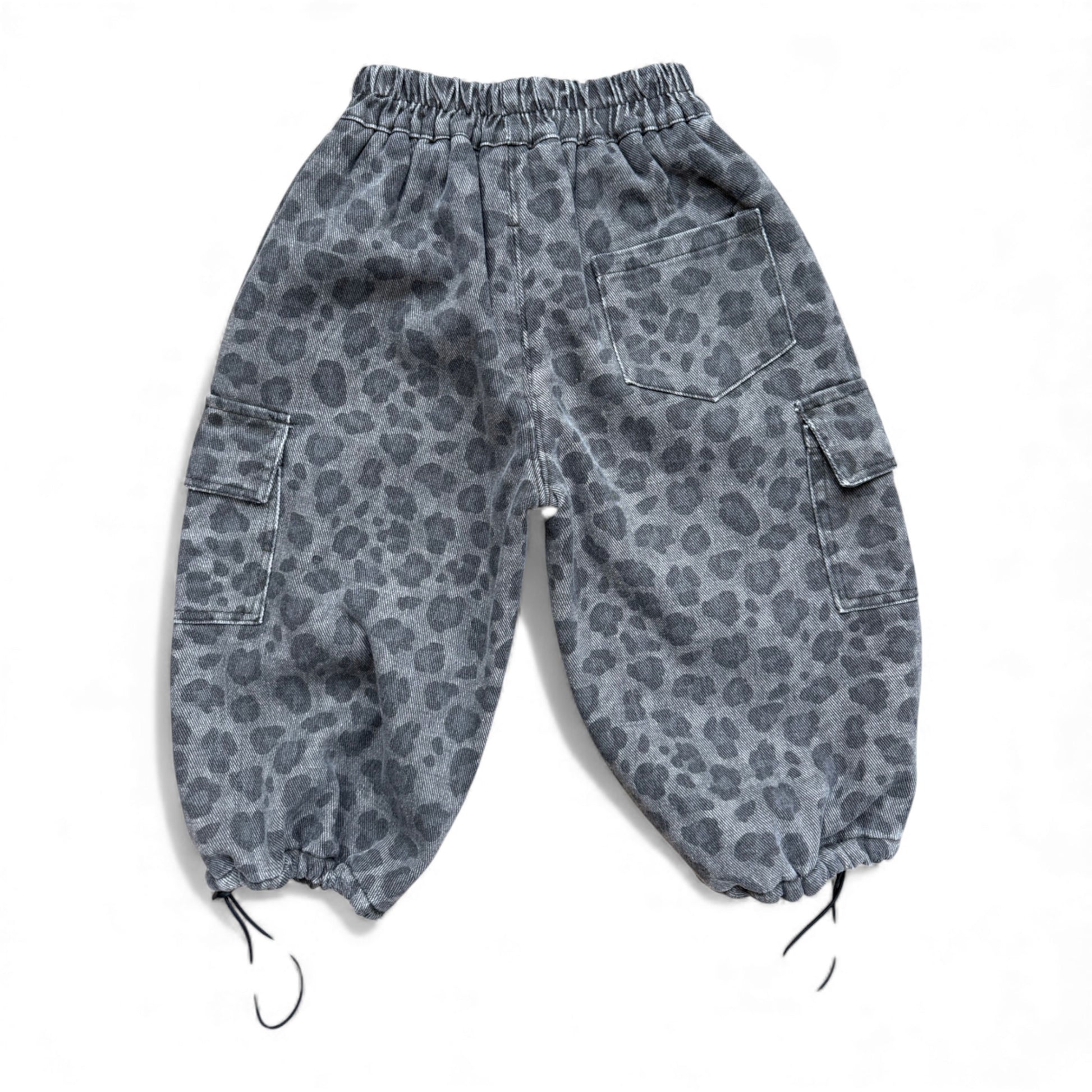 Grey animal-print children’s cargo pants with high elasticated waist, cargo pockets, patch back pocket and drawstring cuffs — back view.