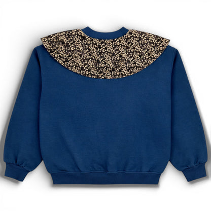 Blue children’s double ply cotton jersey jumper with floral bib detail, balloon cut and ribbed trims - Back view