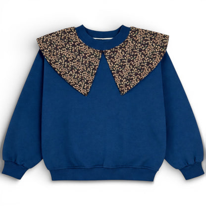 Blue children’s double ply cotton jersey jumper with floral bib detail, balloon cut and ribbed trims - Front view