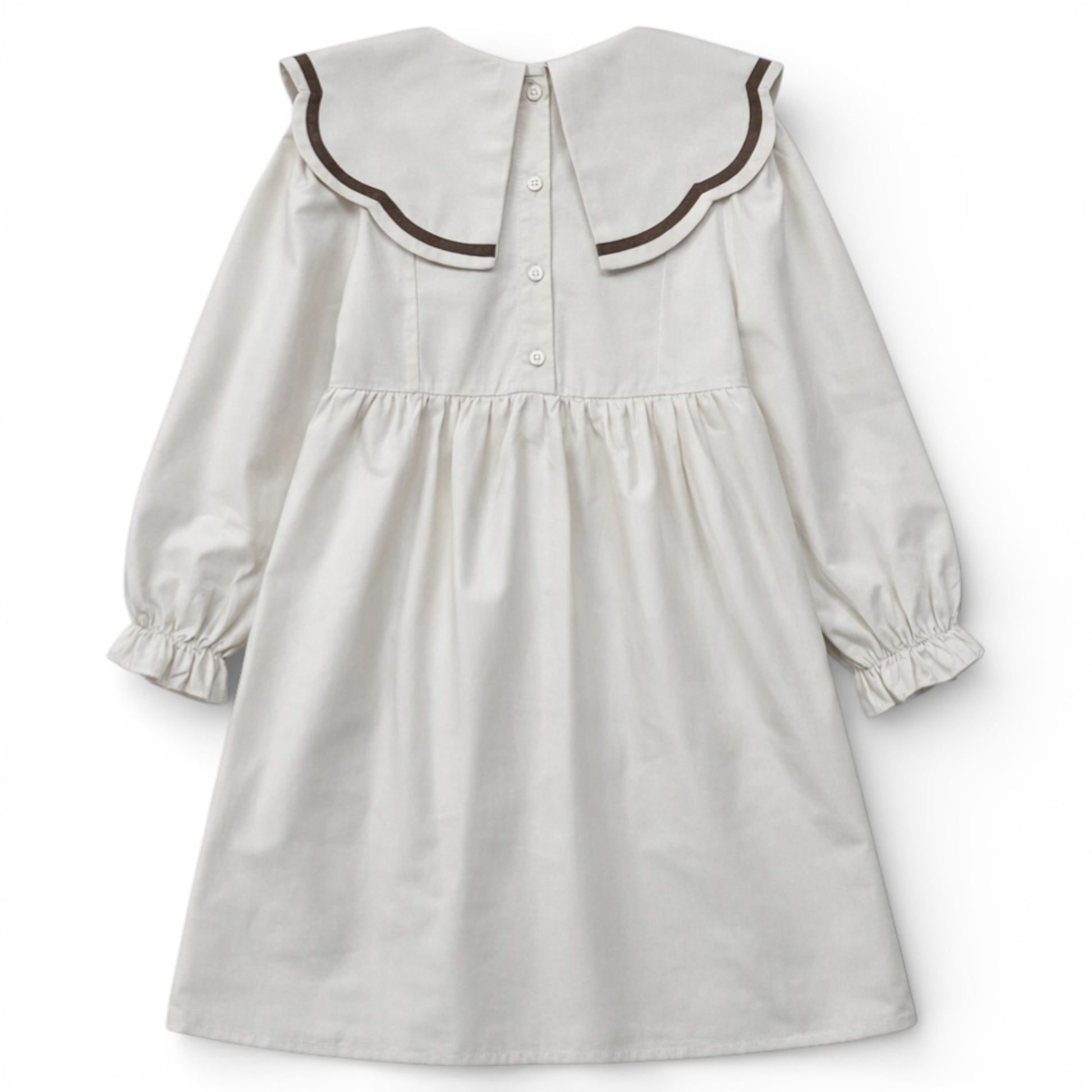 Back view of cream empire dress with split scallop collar and button fastening by That’s Not Fair London.