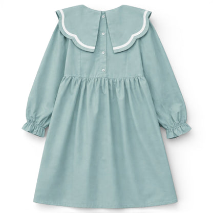 Back view of blue empire dress with split scallop collar and button fastening by That’s Not Fair London.