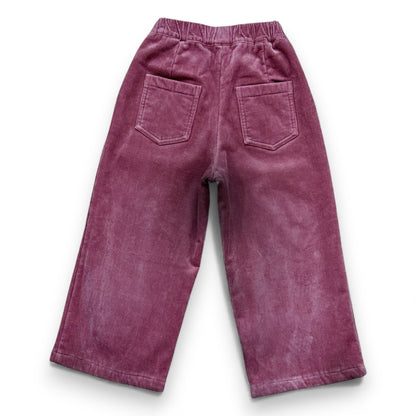 Pastel pink corduroy children’s trousers with wide leg, elastic waistband and patch pockets by That’s Not Fair London