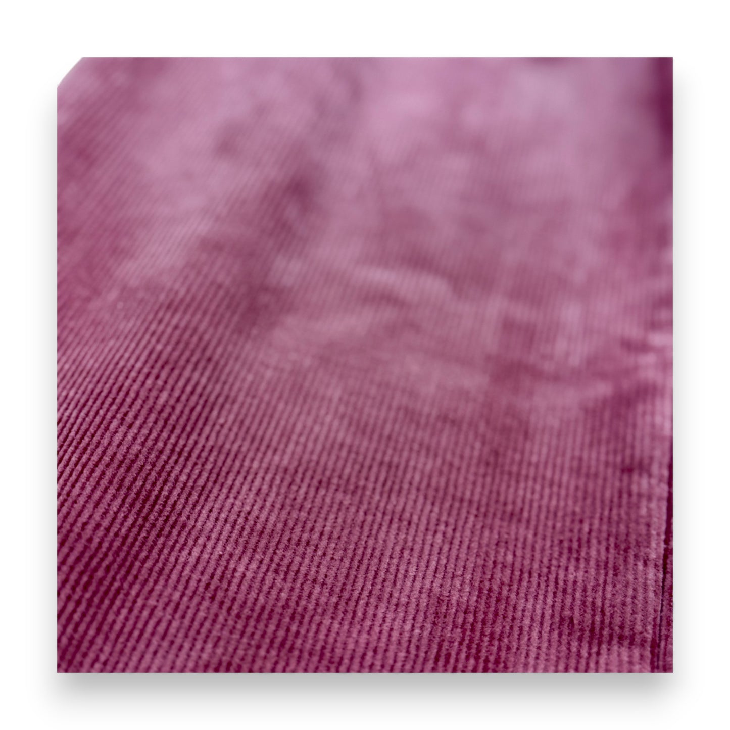 Close-up of pastel pink corduroy fabric showing rib texture and fleece lining by That’s Not Fair London