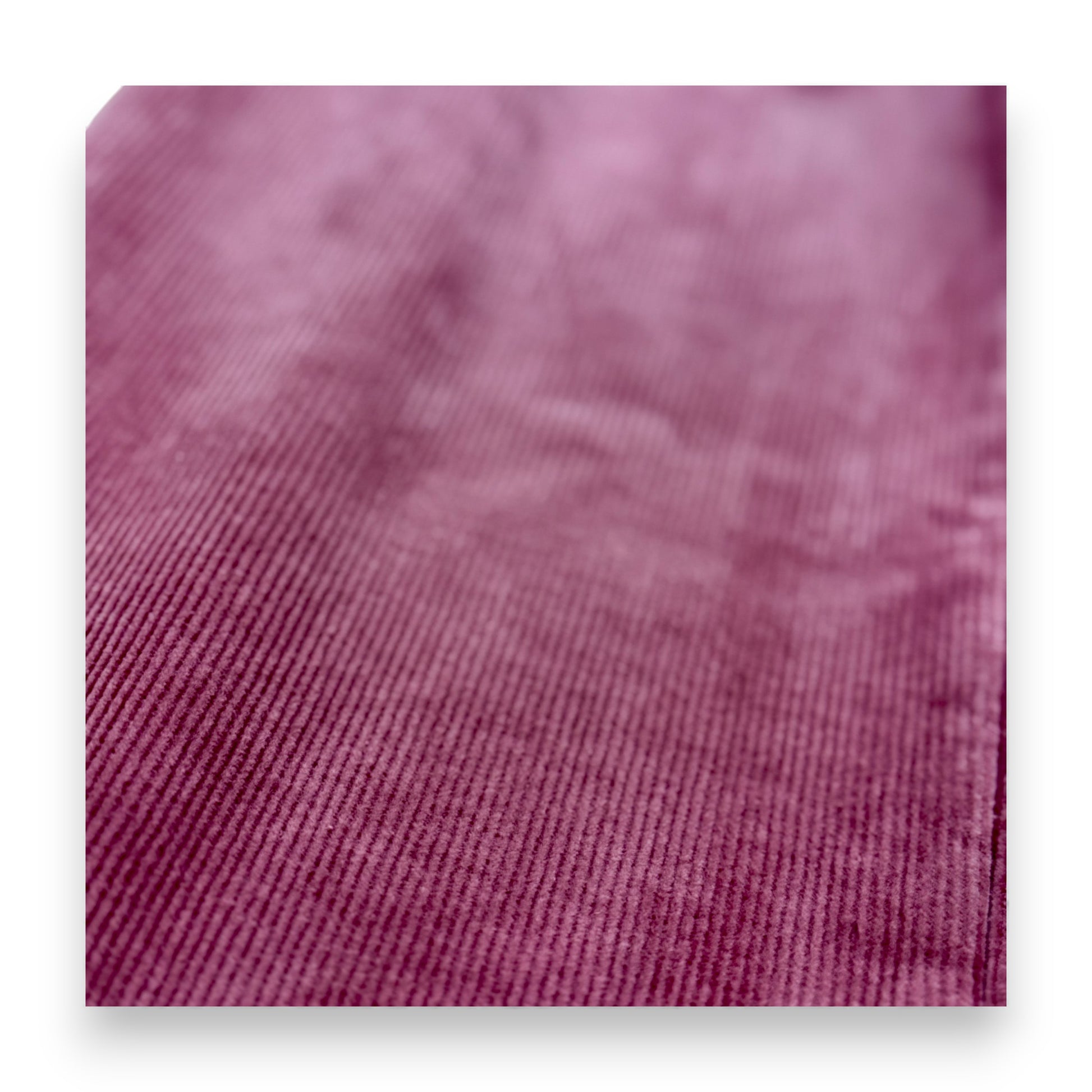 Close-up of pastel pink corduroy fabric showing rib texture and fleece lining by That’s Not Fair London
