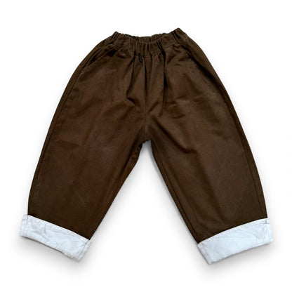 Voluminous cotton balloon trousers with contrast turn-up hem and elasticated waistband.