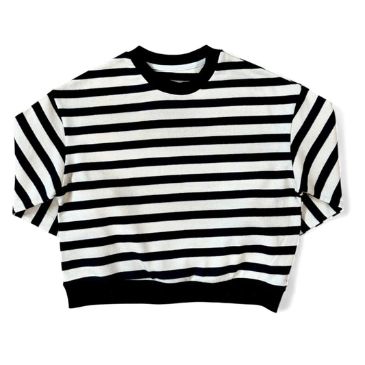 Front view of a black-and-cream striped cotton jersey jumper with ribbed neckline and a relaxed, boxy silhouette.