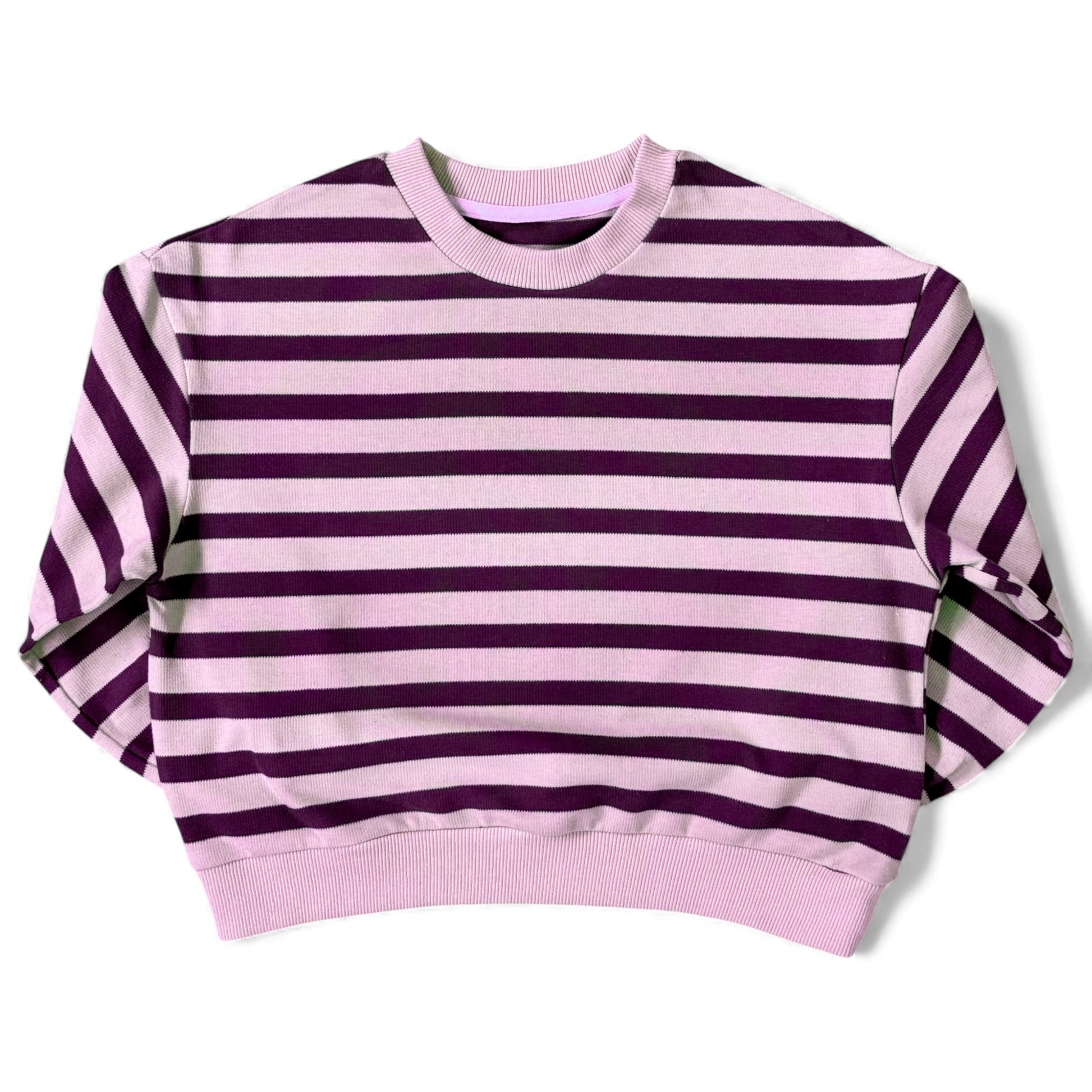 Front view of a lilac-and-purple striped cotton jersey jumper with ribbed neckline and relaxed drop-shoulder sleeves.