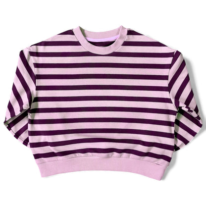 Front view of a lilac-and-purple striped cotton jersey jumper with ribbed neckline and relaxed drop-shoulder sleeves.