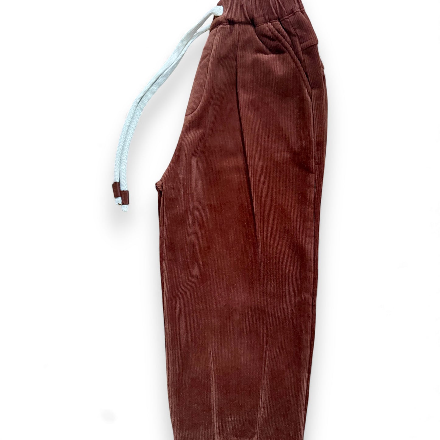 Side view of brick-red corduroy trousers with tapered leg and slant pockets